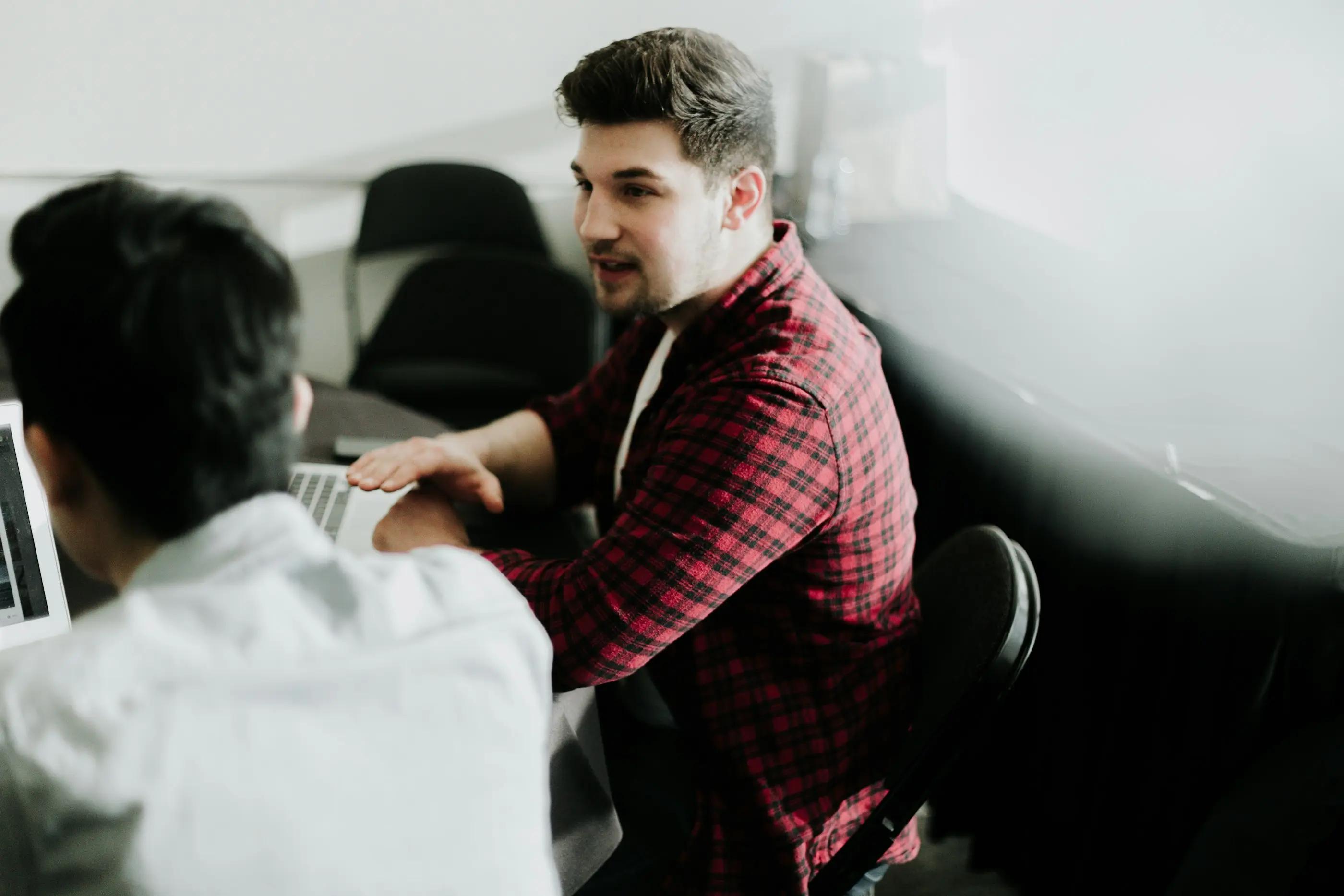 Small business operators collaborating at laptops